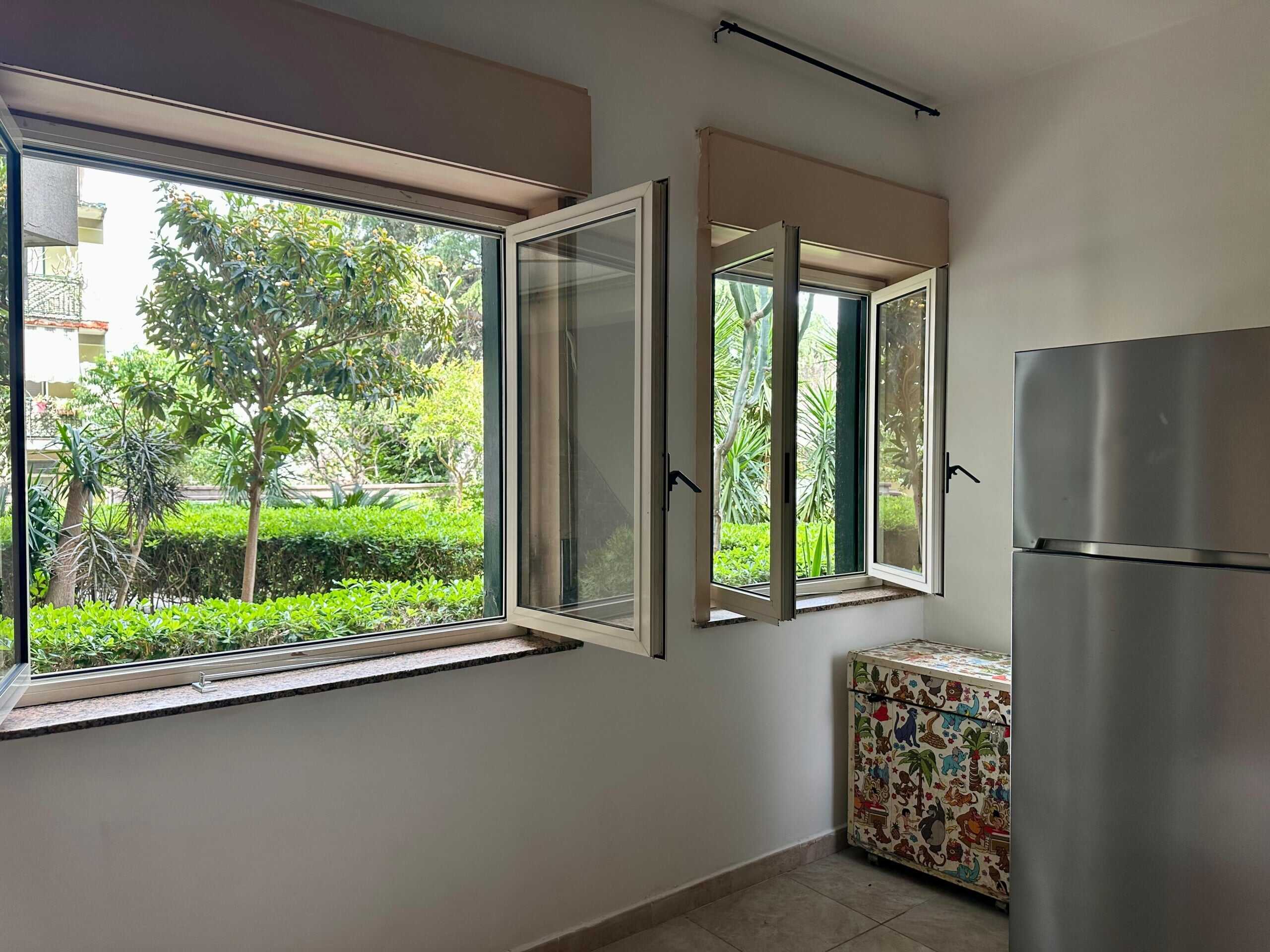 Vista su giardino con grandi finestre apribili, ambiente luminoso e tranquillo, ideale per la cucina o soggiorno, con moderni elettrodomestici e decorazioni accattivanti, in una casa NextCasa.