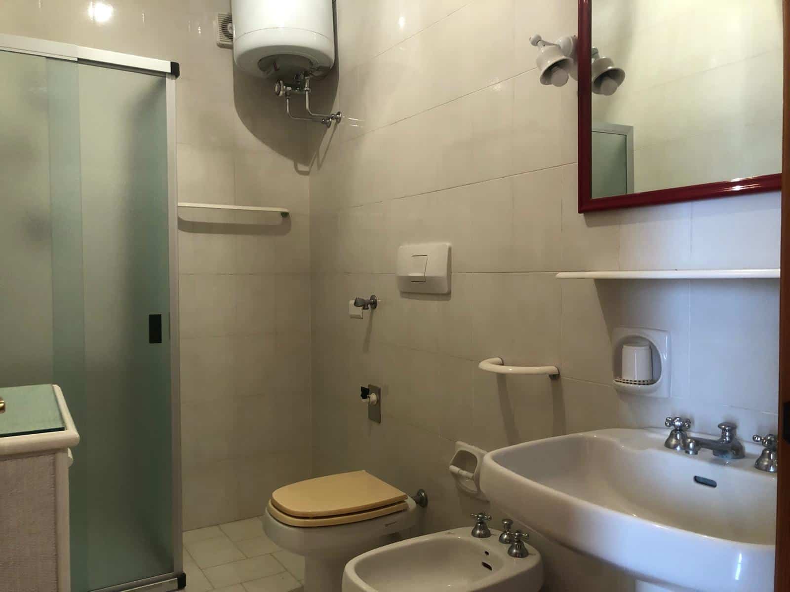 Bagno accessibile con lavabo, bidet, wc e doccia in ambiente compatto, arredi funzionali, tutto progettato per comfort e praticità, ideale per soluzioni di abitazioni o strutture assistenziali.