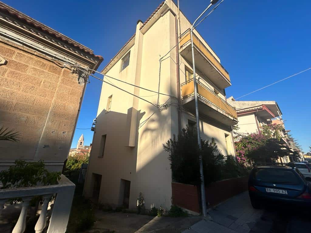 Luxury building in a sunny neighborhood in Italy, modern architecture, residential property, urban living, NextCasa real estate, apartment complex, picturesque street scene, Italian cityscape, property for sale, real estate Italy.