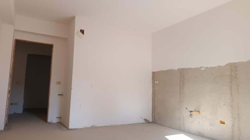 Nuova casa in costruzione con pareti interne in fase di finitura, ambiente spazioso e luminoso, ideale come opportunità di investimento immobiliare a NextCasa.