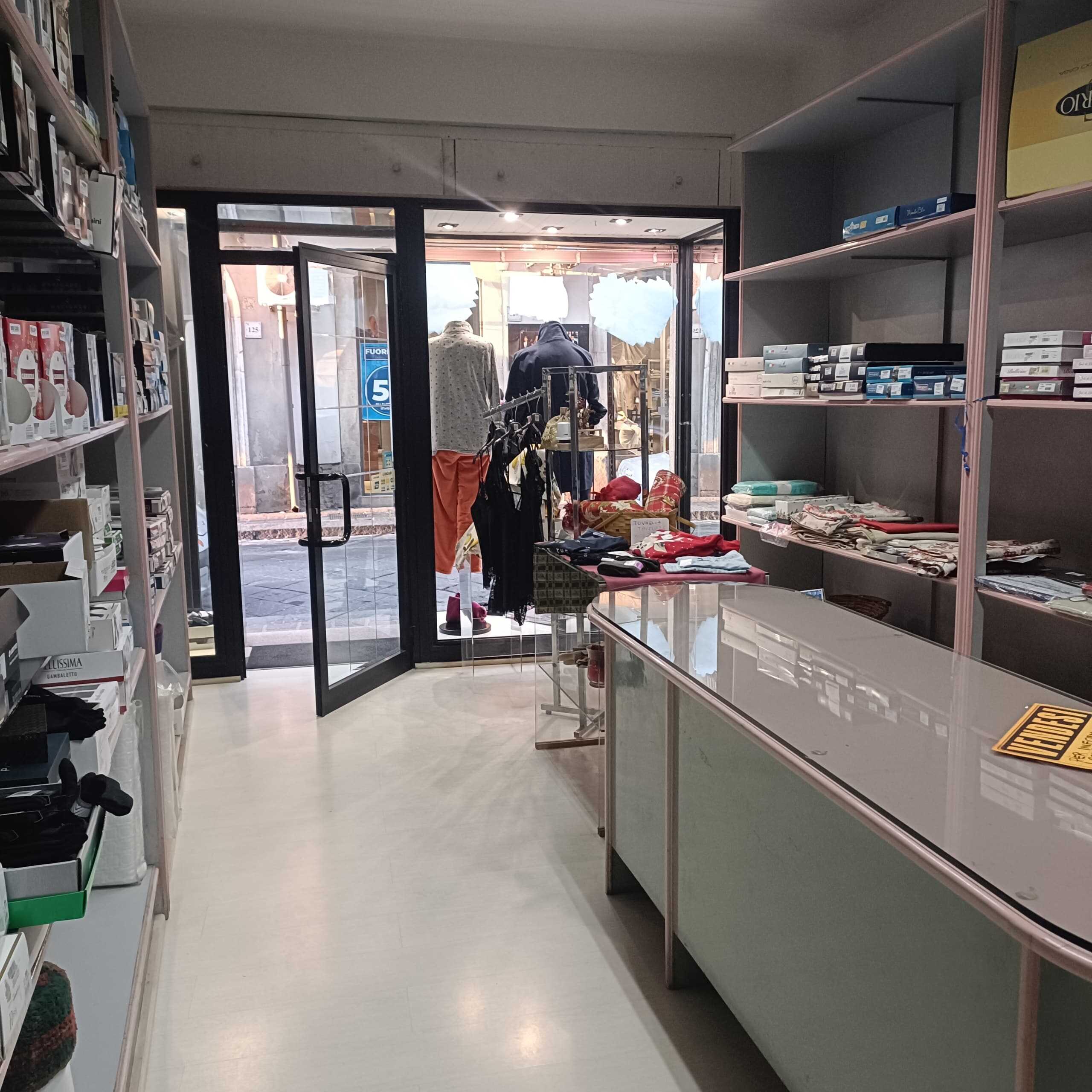 Vendita abbigliamento e accessori usati in negozio di seconda mano NextCasa, atmosfera accogliente, prodotti di qualità e prezzi convenienti, spazio di vendita con esposizione ordinata e ingresso luminoso.
