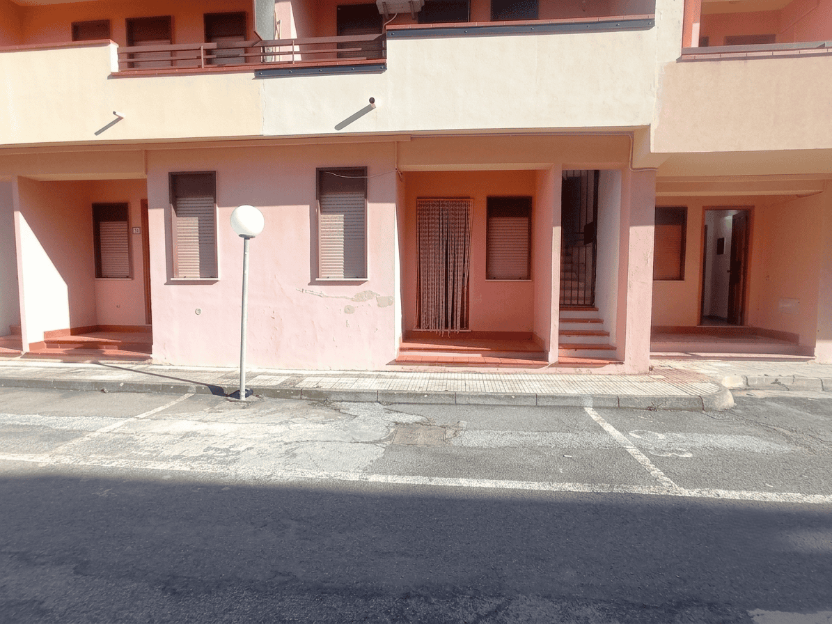 Facciata di un appartamento in vendita in via Stazione 90, Oliveri, Me, con ingresso e balcone al primo piano.