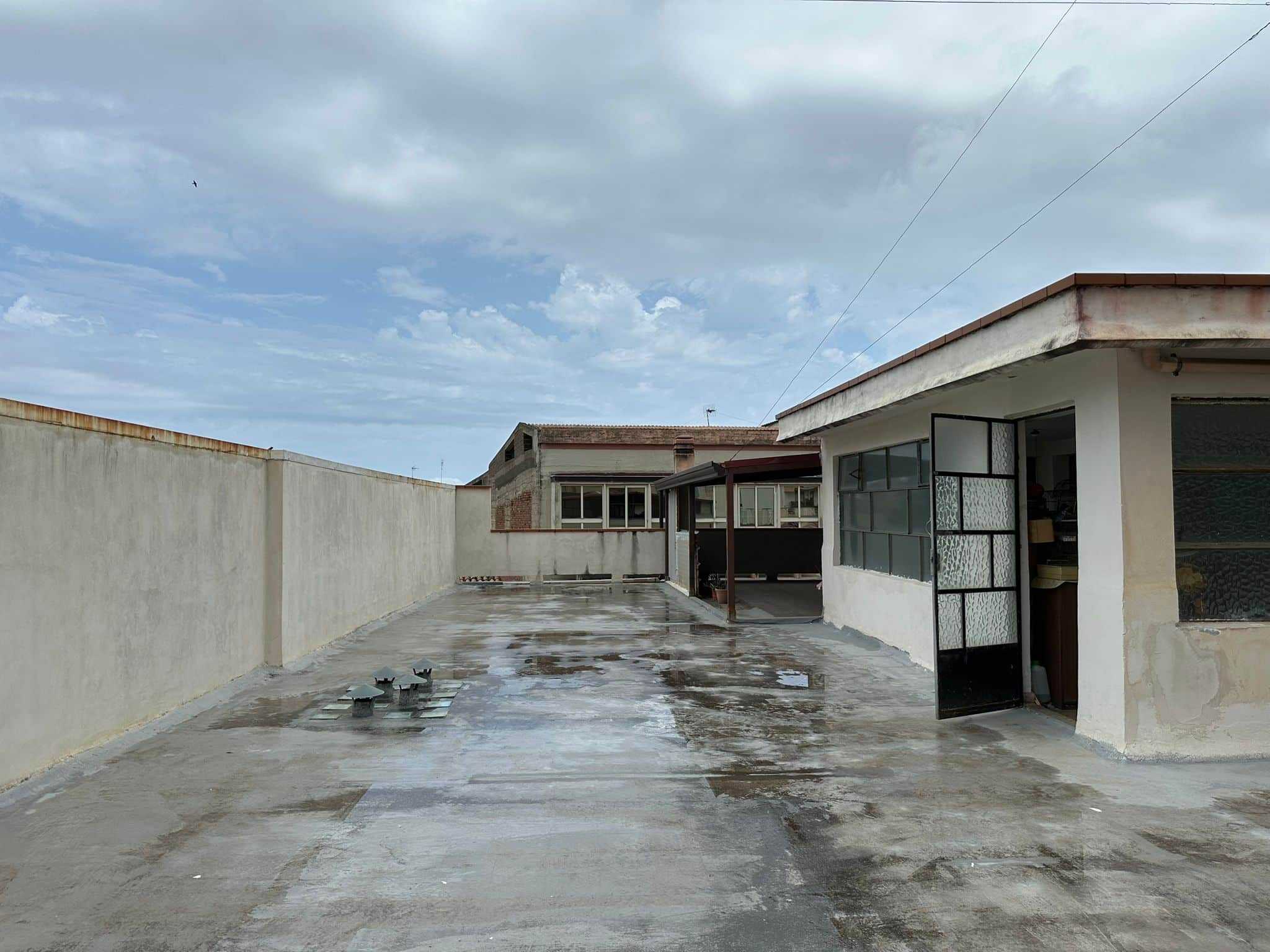 Tettoie e terrazza panoramica di un appartamento con vista sulla città, facciata rinnovata e spazio esterno spazioso, ideale per godersi l'aria aperta e il relax.