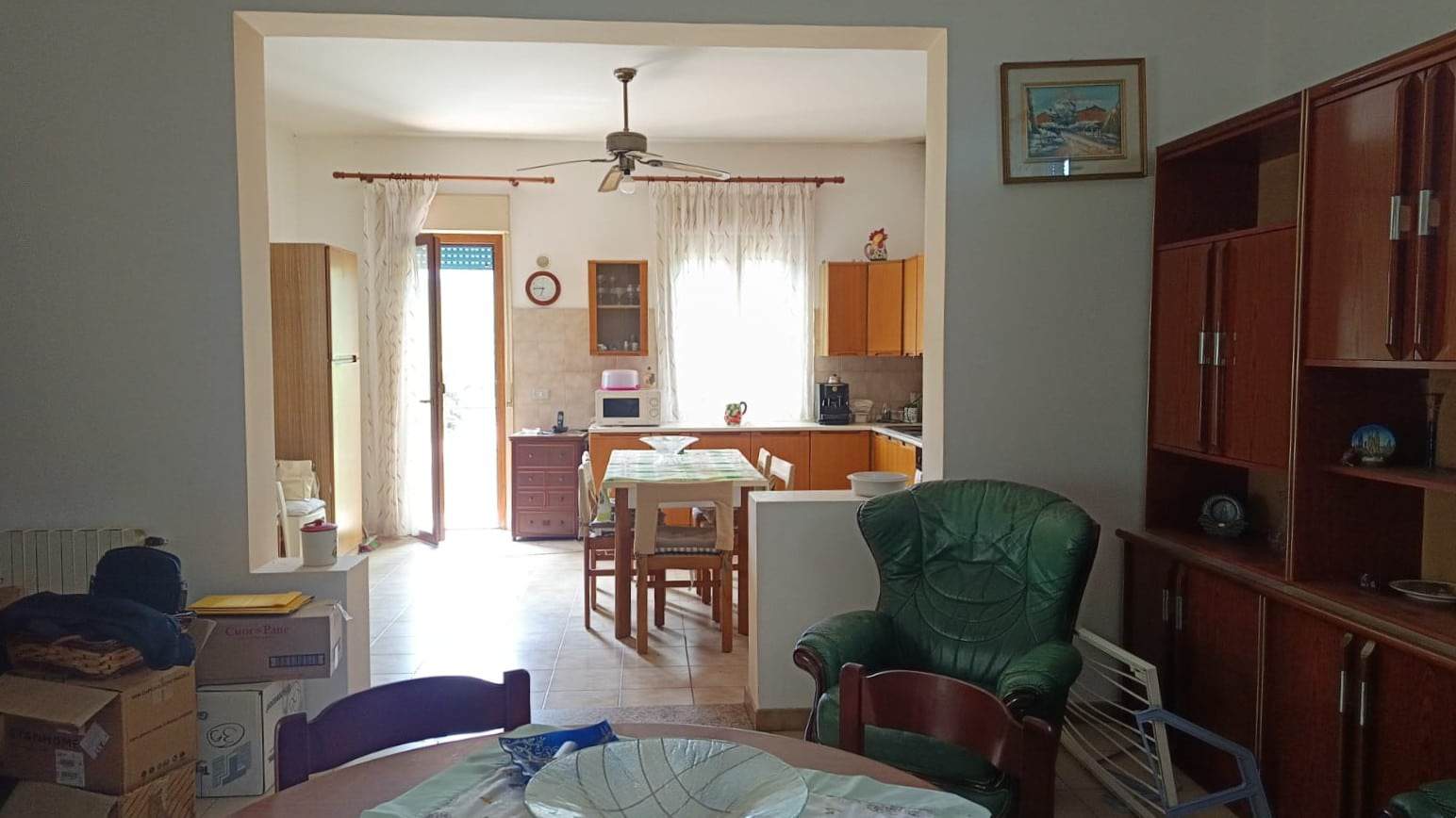 Casetta con soggiorno e cucina abitabile, arredamento semplice e accogliente, con mobili in legno e zona pranzo luminosa, ideale per brevi soggiorni o famiglia.