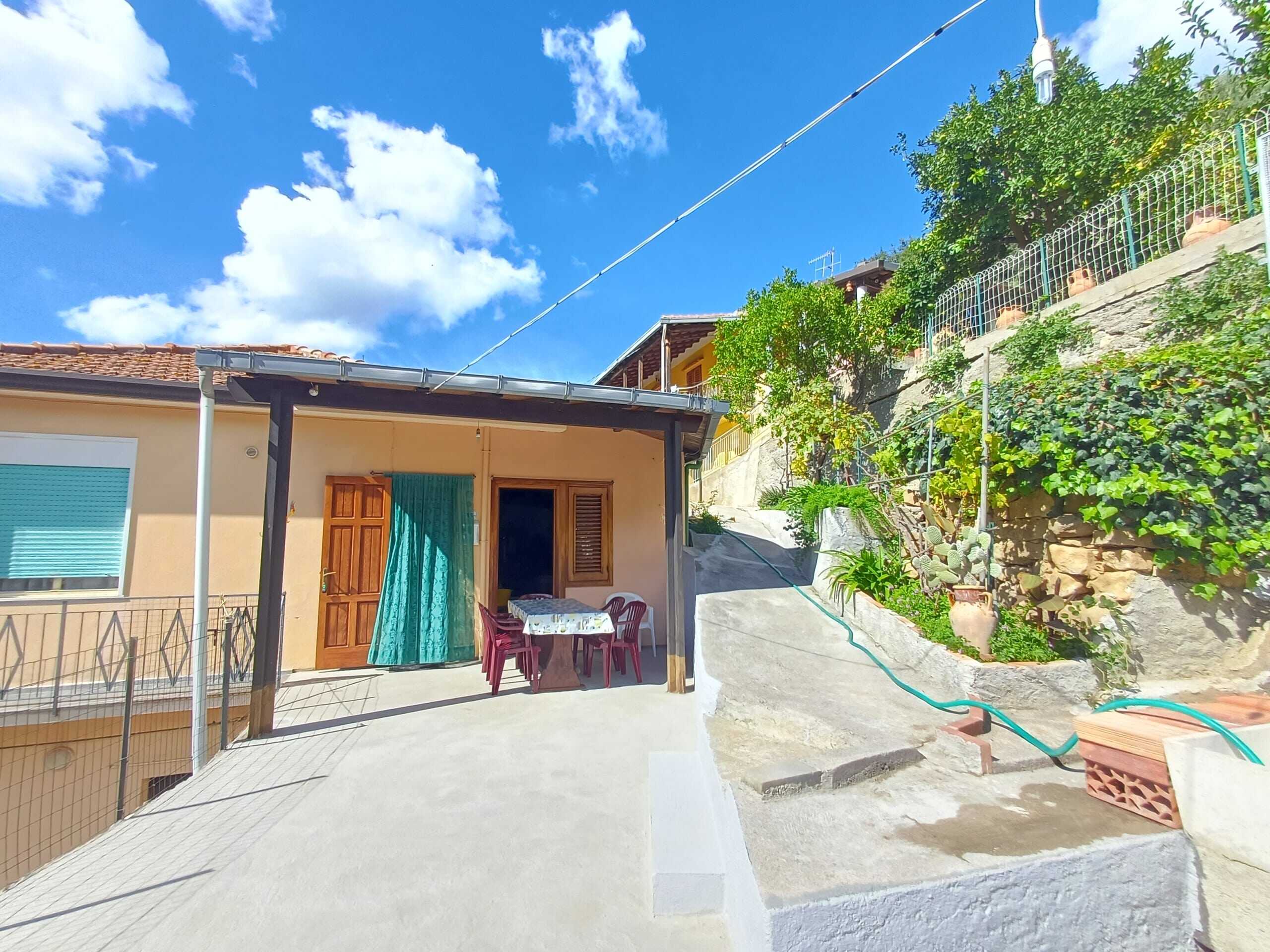 20251009_115802 Balcone con terrazza soleggiata e vista su giardino eCASE in Italia, ideale per attività all'aperto e relax. Viene mostrato un appartamento in stile mediterraneo, perfetto per soggiorni estivi e investimento immobiliare.