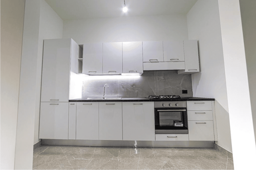 Cucina moderna caratterizzata da mobili bianchi, finitura elegante e funzionale, perfetta per arredare ambienti residenziali con stile minimalista.