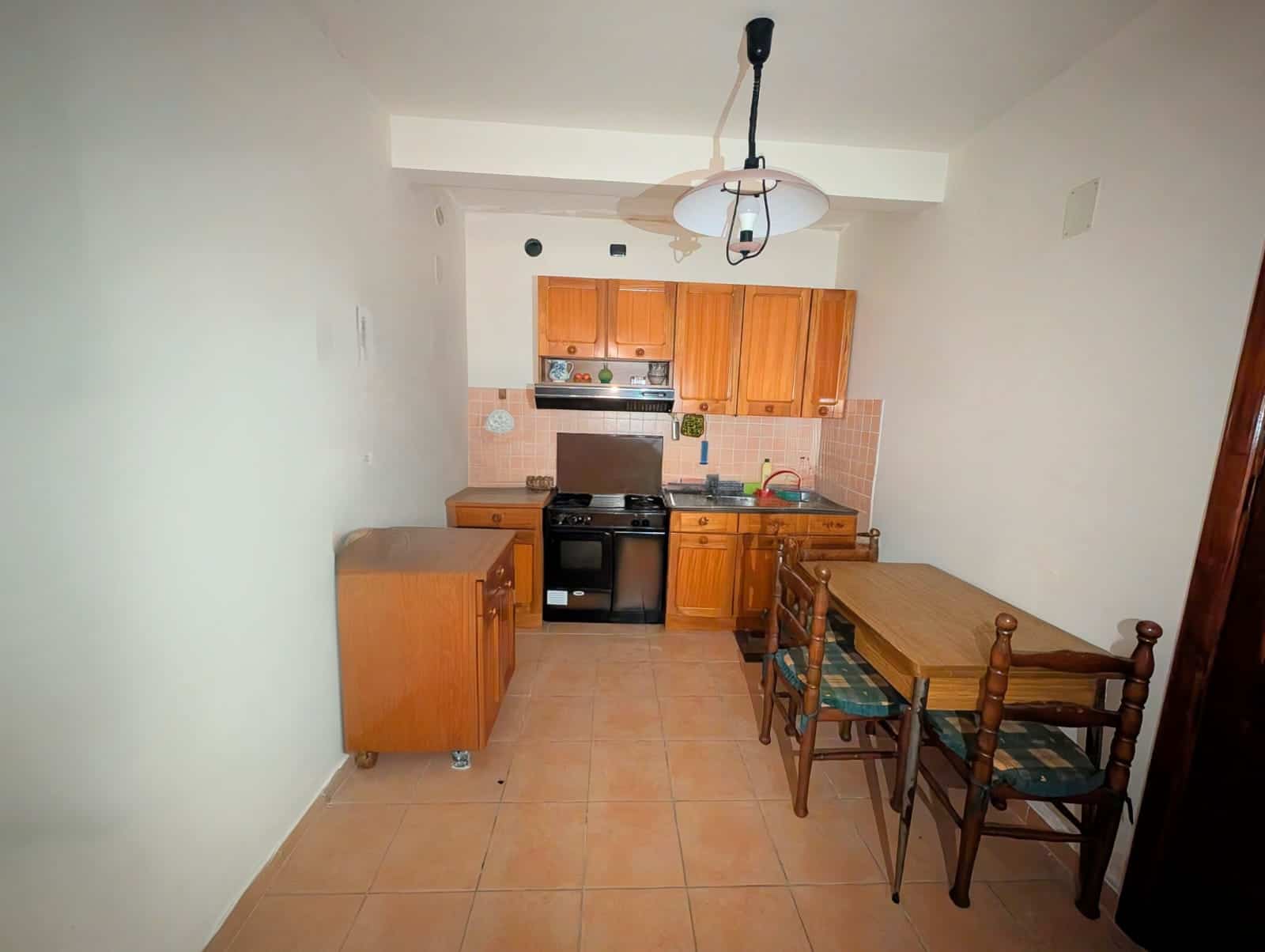 1. Cucina compatta con mobili in legno, piano cottura, forno e lavabo, stile classico, in un appartamento in affitto a NextCasa Italia.