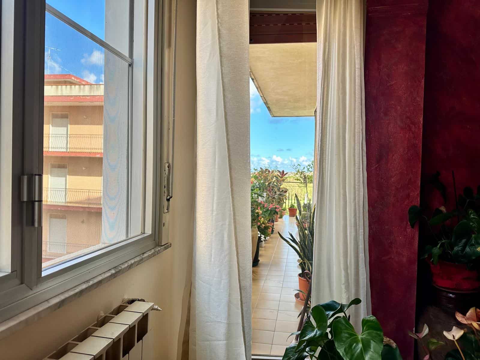 Vista balcone con piante e giardino, luce naturale, appartamento in vendita NextCasa, immobile con terrazza, spazio verde, vista aperta, ambiente luminoso e accogliente, stile moderno e confortevole.