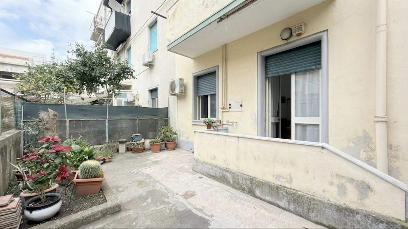 Appartamento con balcone e giardino esterno, zona residenziale tranquilla, con piante e decorazioni, ideale per relax e vita all'aperto.