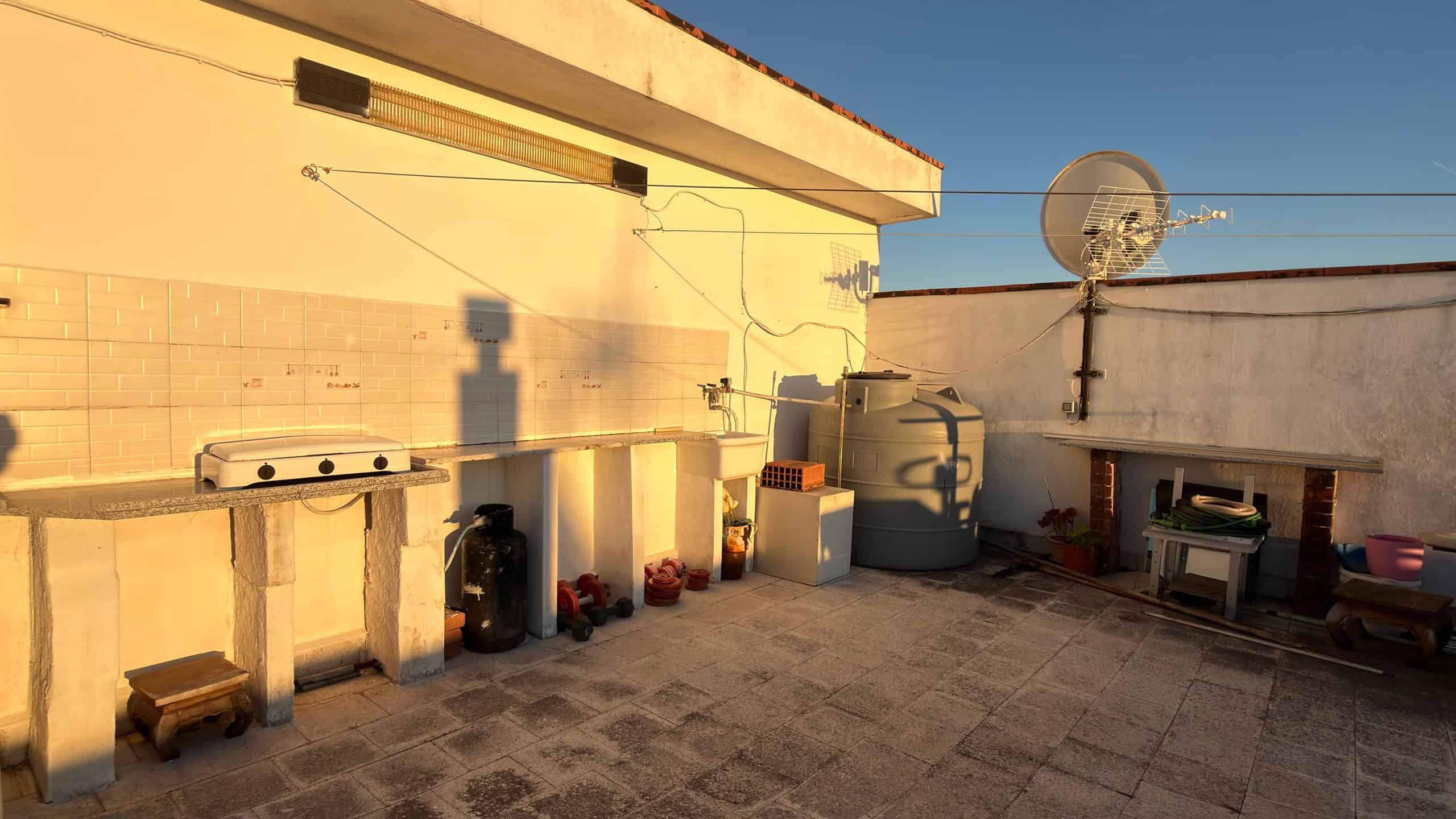 Pannello solare e area esterna con barbecue e attrezzature per barbecue, spazio all'aperto soleggiato e funzionale, ideale per cene e momenti di relax all'aperto.