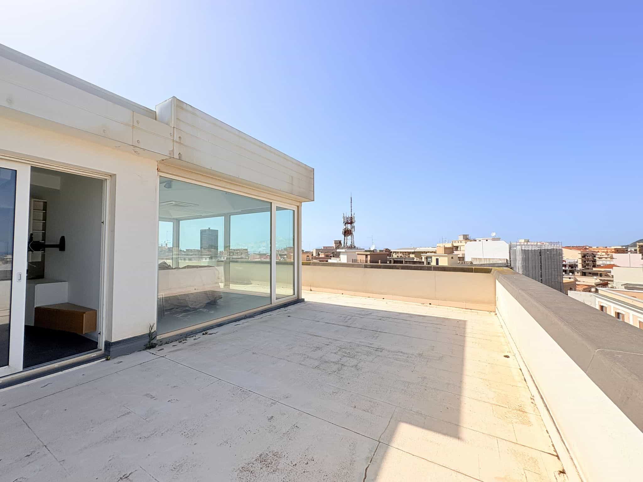 Terrazza panoramica con vista sulla città, spazio esterno di un appartamento moderno in centro urbano, ideale per relax e socializzazione all'aperto.