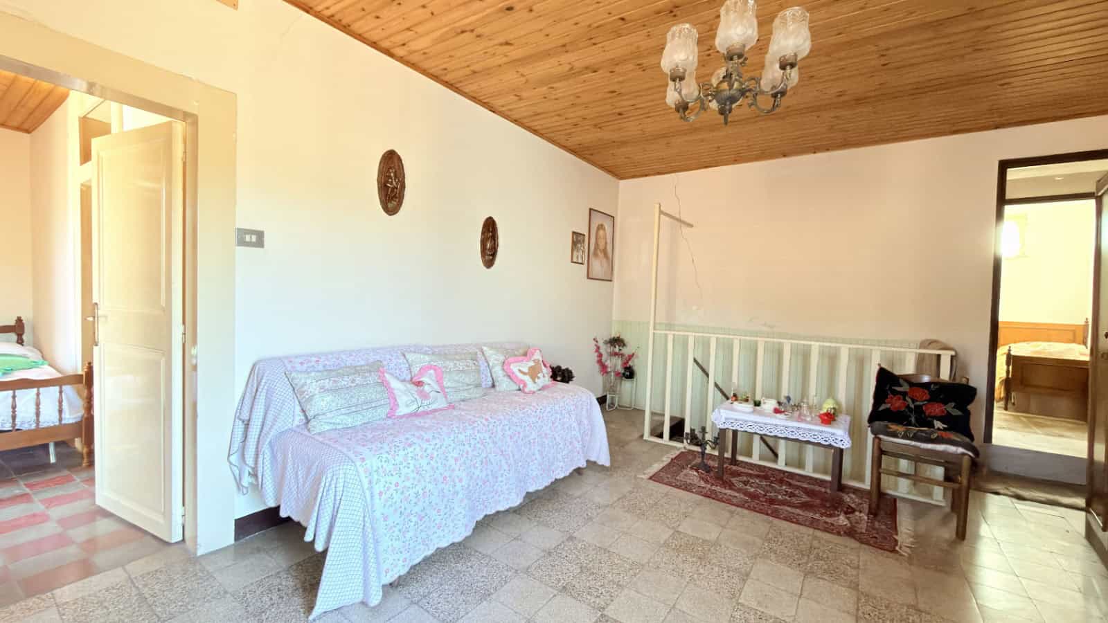 Soggiorno accogliente con divano e area relax, ideale per affitti turistici o residenziali, con arredi tradizionali e atmosfera calda, perfetta per vivere momenti di comfort e tranquillità.
