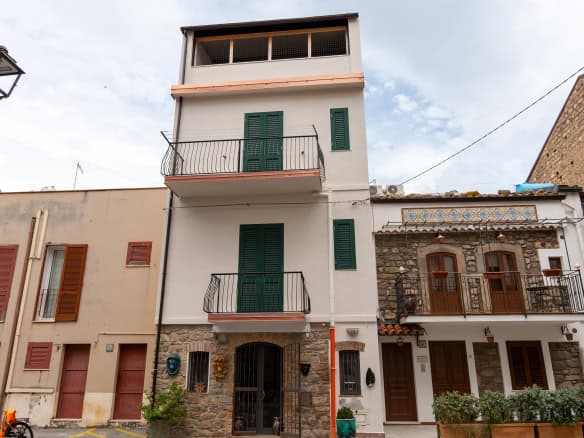 Edificio residenziale moderno con balconi e facciata bianca, situato in zona urbana di NextCasa, ideale per investimenti immobiliari e affitti turistici in Italia.