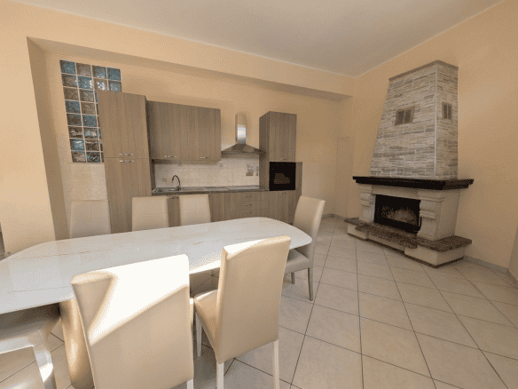 Cucina moderna con tavolo da pranzo e camino in soggiorno, arredamento elegante e funzionale, ambiente luminoso e accogliente.