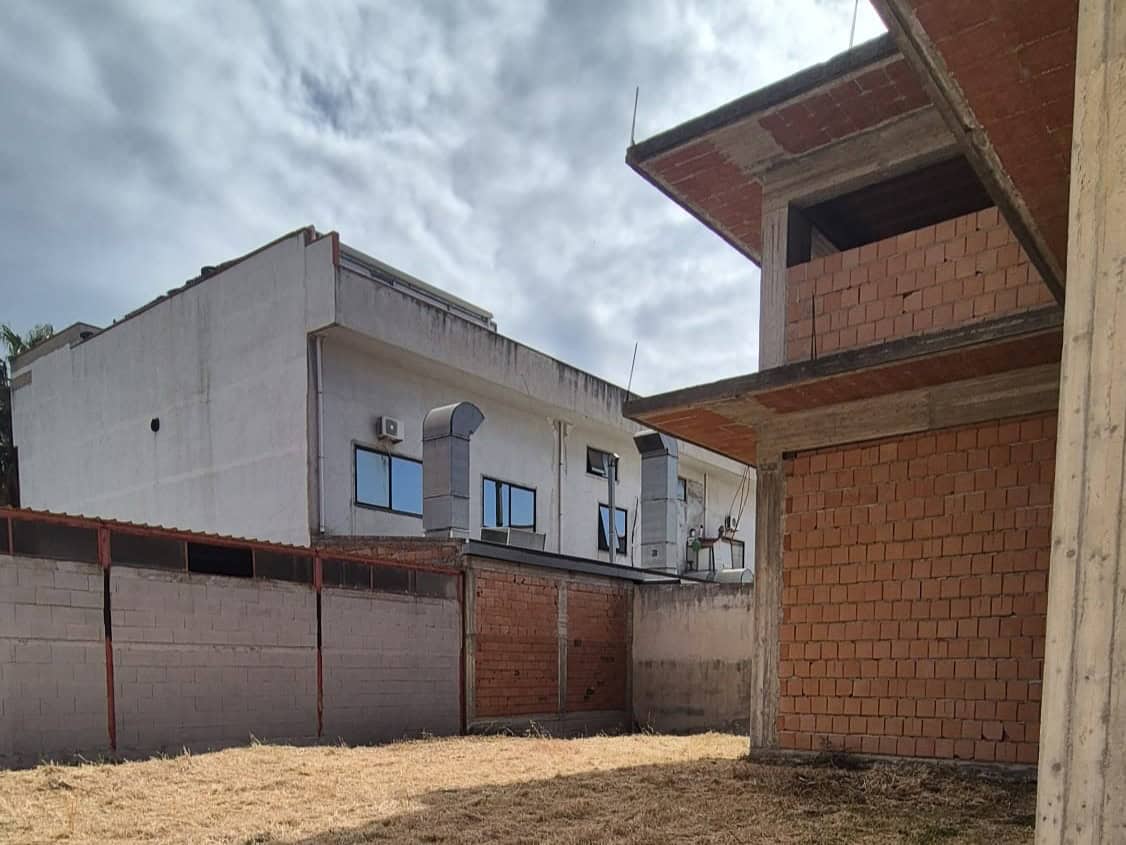 Vero, senza persone, un cantiere edile con edifici in costruzione e muri di mattoni, cielo nuvoloso, area di lavoro all'aperto, prossima a essere completata, rappresenta un progetto di sviluppo immobi.