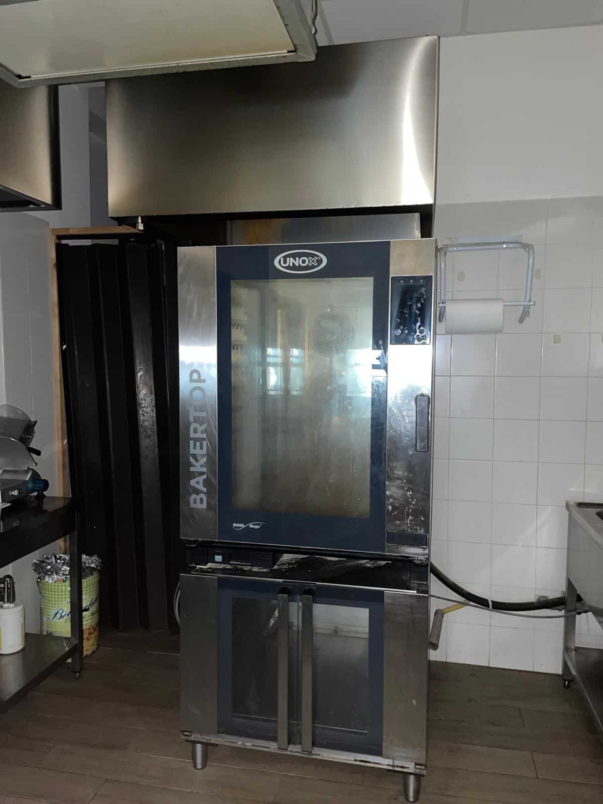 Il forno professionale UNOX BakeryPro in cucina, ideale per la preparazione di prodotti da forno, con display touchscreen e struttura in acciaio inox, perfetto per pizzerie e panetterie.