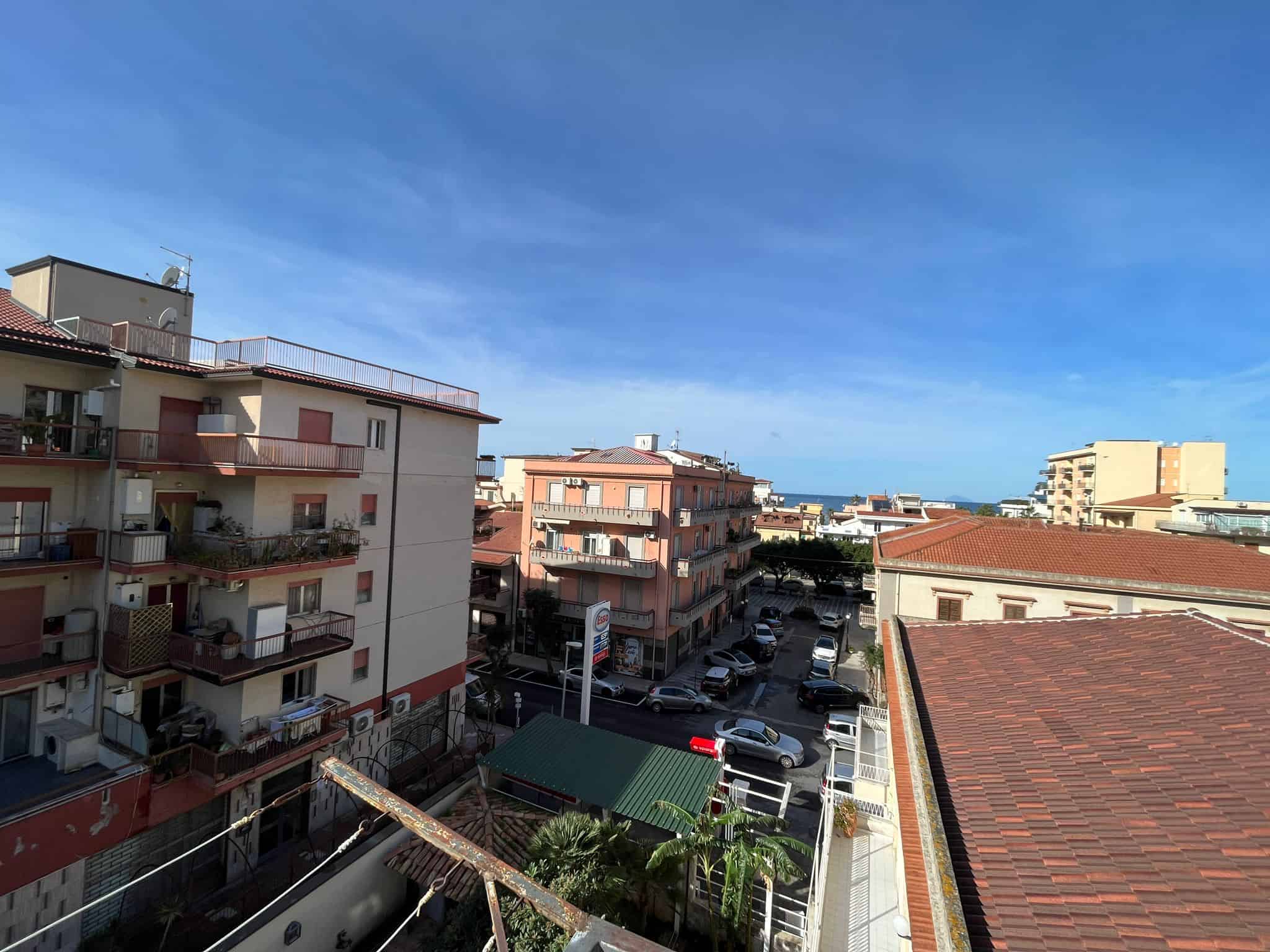 VISTA PANORAMICA di un quartiere urbano con edifici residenziali e strade trafficate, sotto un cielo sereno, in un'immagine che evidenzia l'ambiente cittadino e la vita quotidiana.
