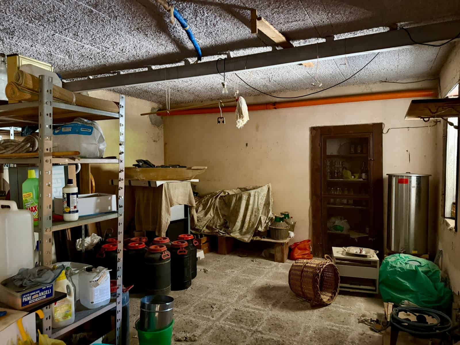 Deposito di garage con scaffalature, contenitori e attrezzi, ambiente di stoccaggio domestico.