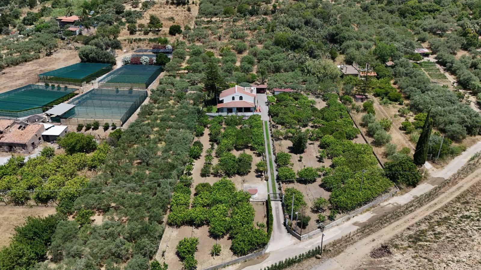 Vista aerea di un'ampia proprietà con giardini, alberi e strutture agricole in Contrada Rosa, Terme Vigliatore, Me.