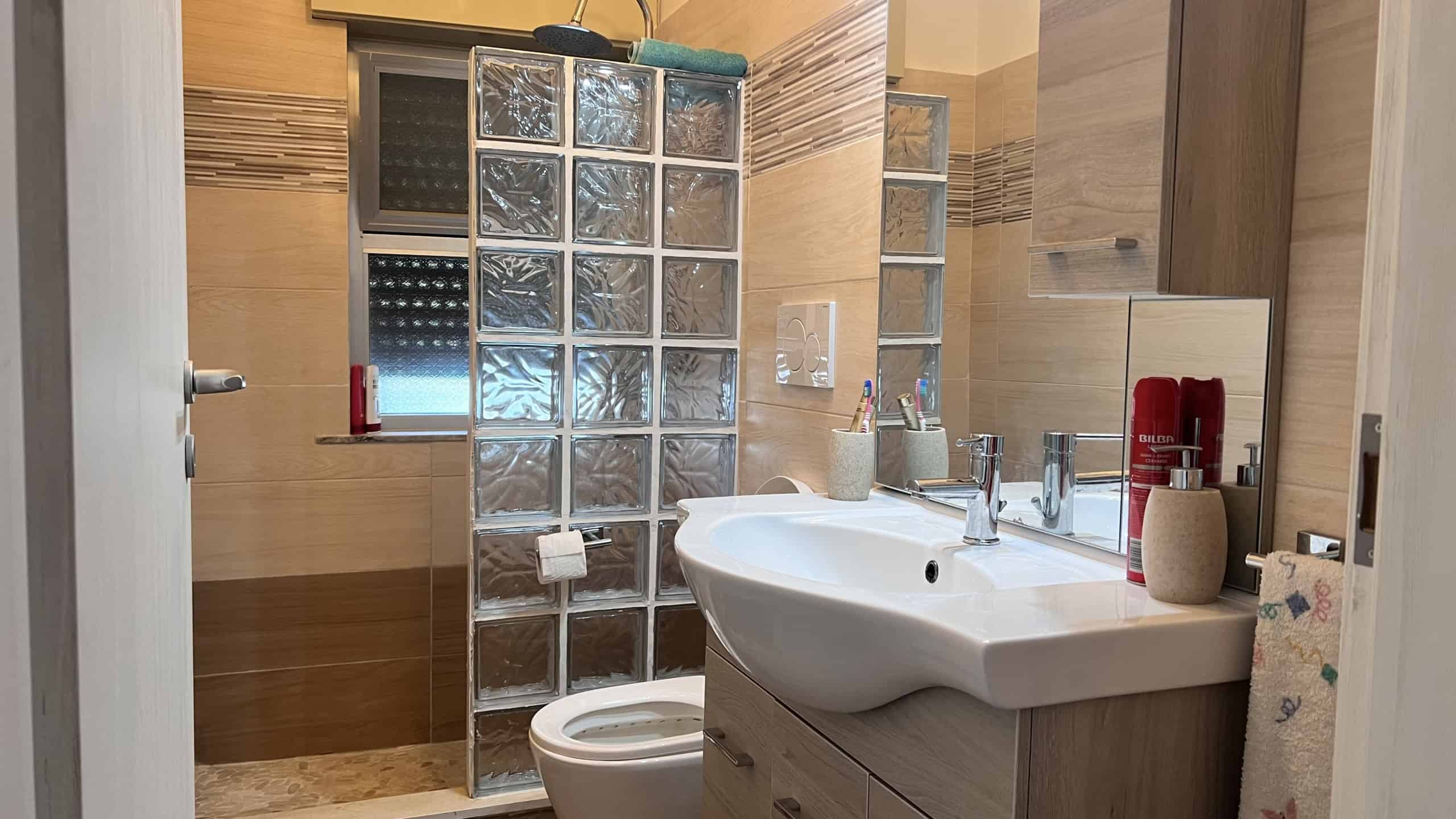Bagno con lavabo, specchio e doccia in appartamento in vendita a Acqualadroni, Me.