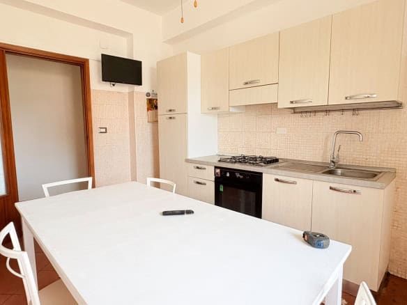 Cucina moderna in appartamento in affitto a Milazzo con mobili chiari e elettrodomestici.