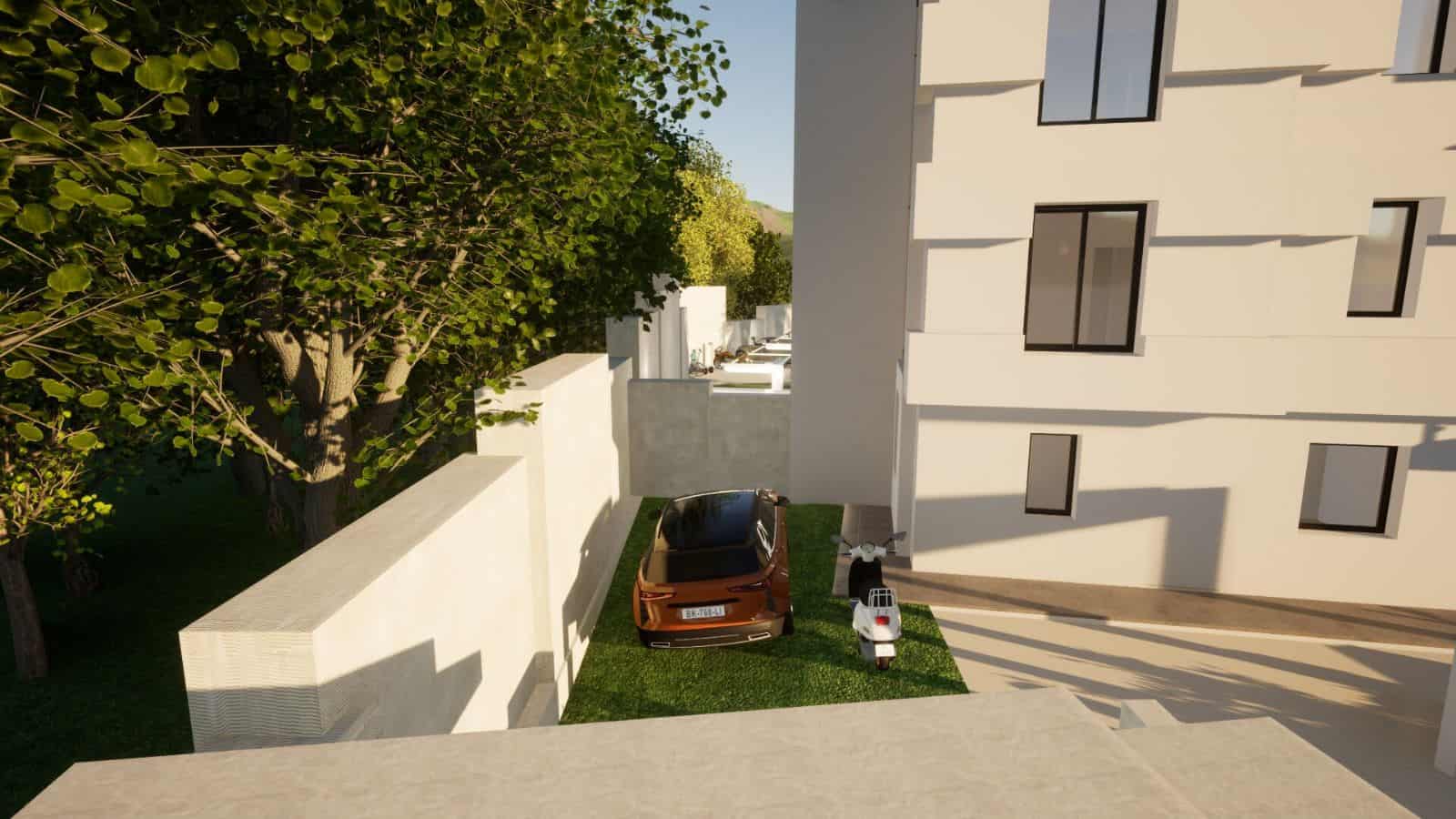Vista dell'esterno di un appartamento in vendita a Capo D'Orlando, con parcheggio e giardino privato.