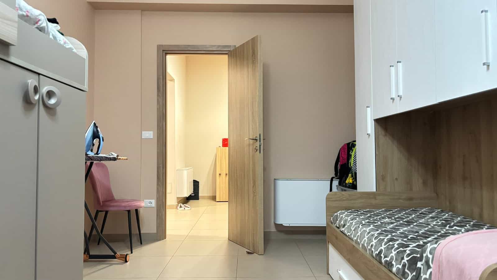 Interno di un appartamento in vendita a Milazzo, con ingresso, armadio, sedie e porta aperta verso un'altra stanza.